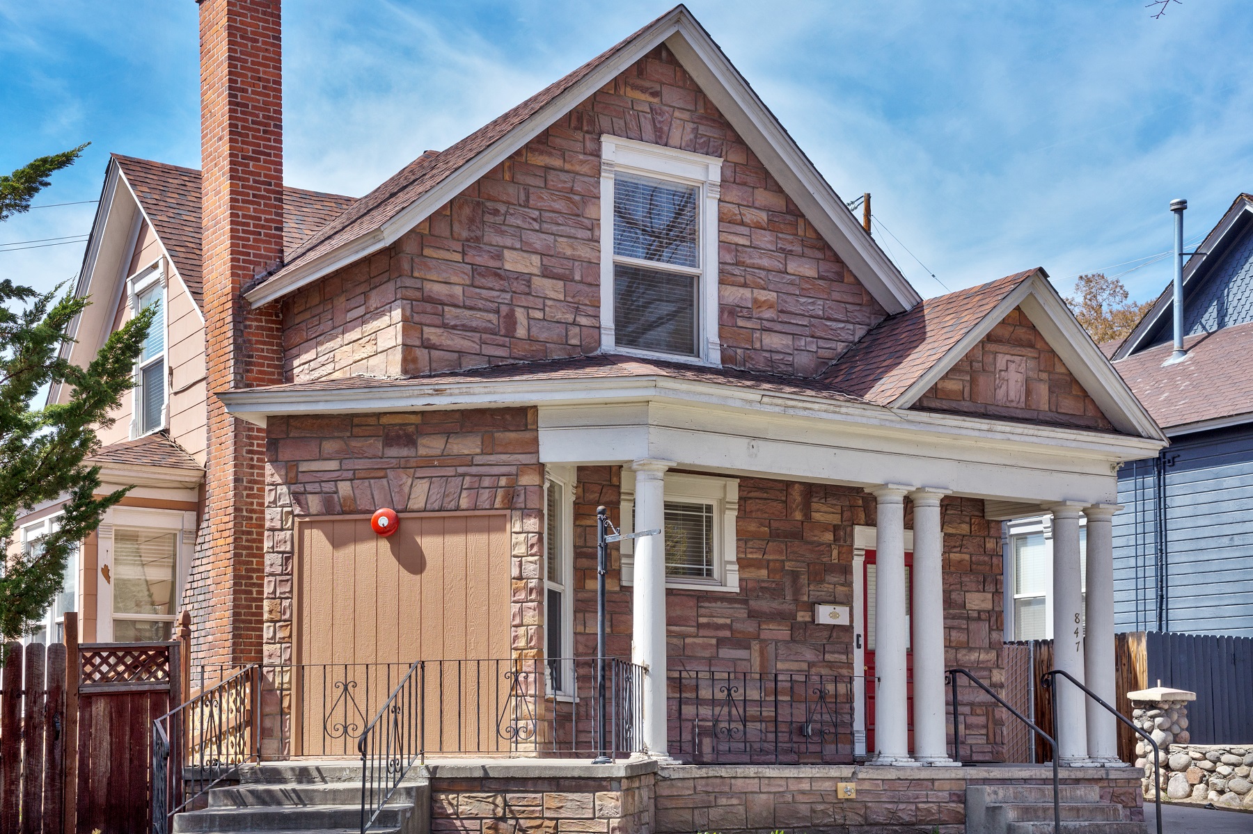 841 Center Street is a home with beautiful stonework and a small cross fashioned into one of the roof peaks